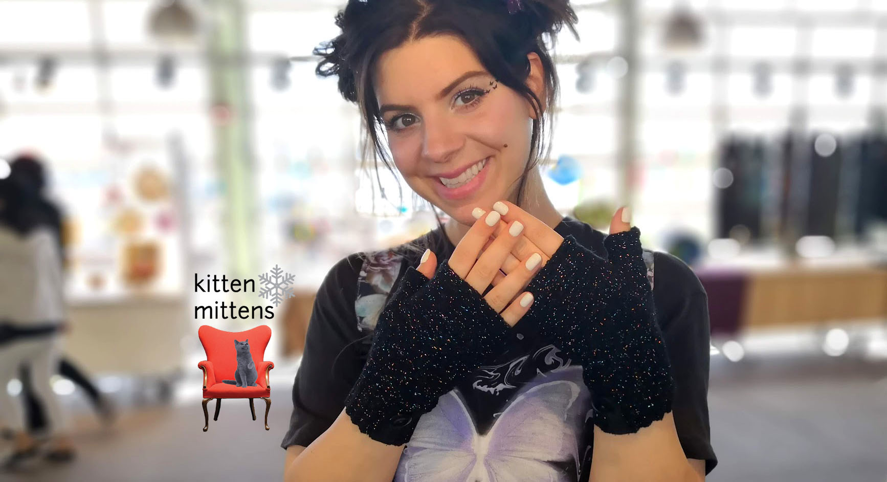 Woman wearing short black fingerless Kitten Mittens