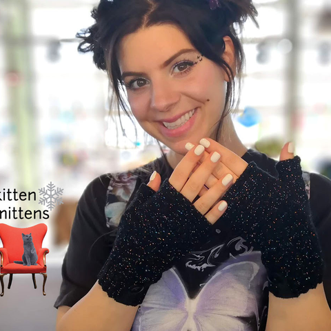 Woman wearing short black fingerless Kitten Mittens