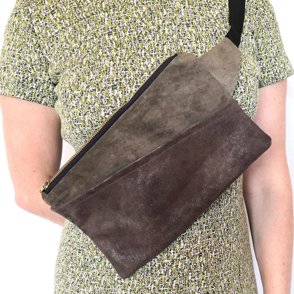 Person wearing moss and metallic bronze suede fanny pack crossbody