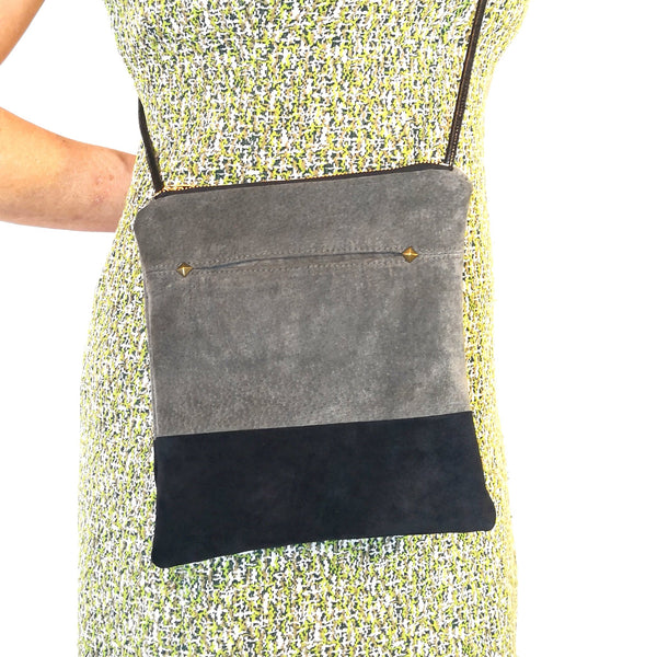 Person wearing olive and black recycled suede Fringe Vintage Leather crossbody bag