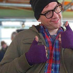 Man wearing purple fingerless recycled sweater gloves handmade by Kitten Mittens.