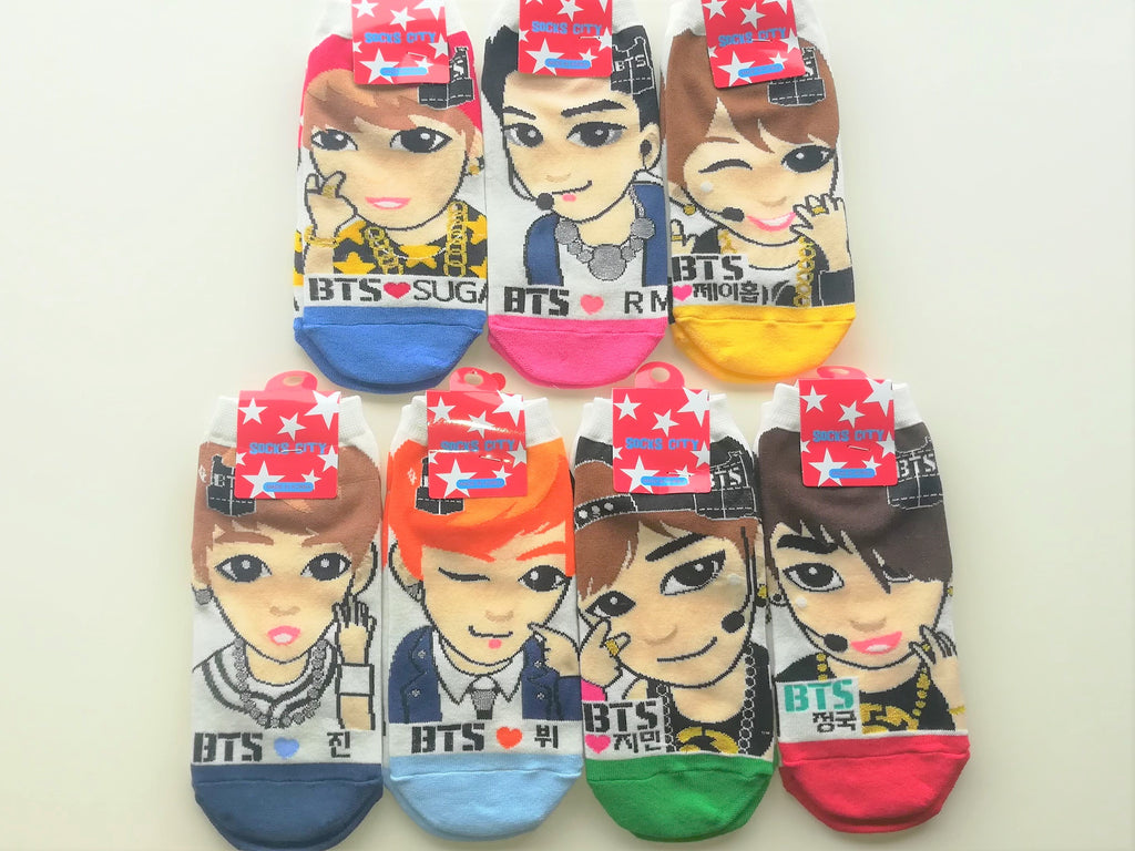 Seven-pair collection of H-Mart BTS graphic socks used to make Kitten Mitten's BTS fingerless gloves
