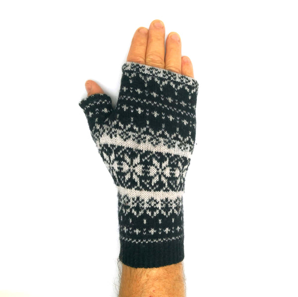 Man's hand in a fingerless glove made from a recycled fair isle wool sweater.