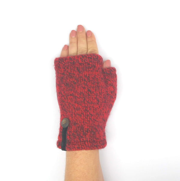 Woman's hand in orange and black heather wool fingerless mitten