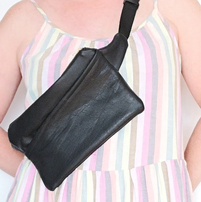 Woman wearing black recycled leather fanny pack crossbody