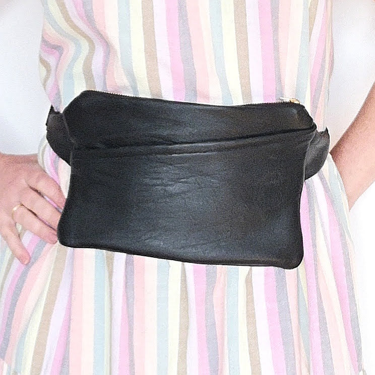 Woman wearing Fringe Vintage black recycled leather fanny pack around her waist
