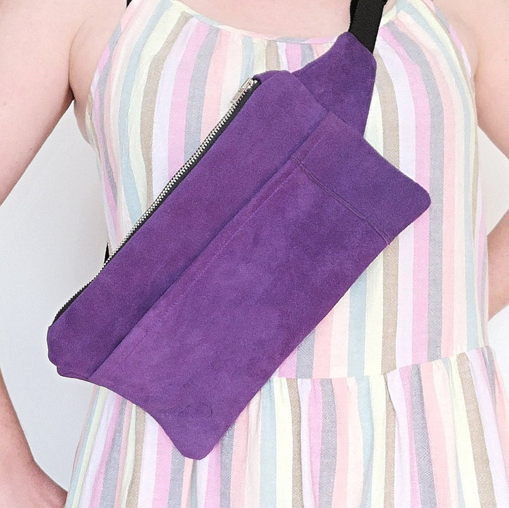 Person wearing recycled purple suede fanny pack crossbody