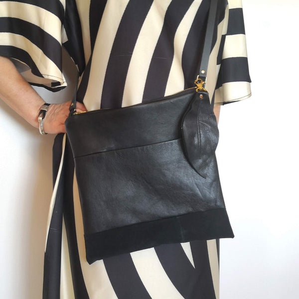 Sustainably fashionable purse worn by a woman in a vintage striped dress
