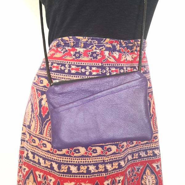Person wearing upcycled purple leather minibag with diagonal cut front pocket